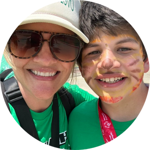  boy with his face painted and woman wearing sunglasses and hat
